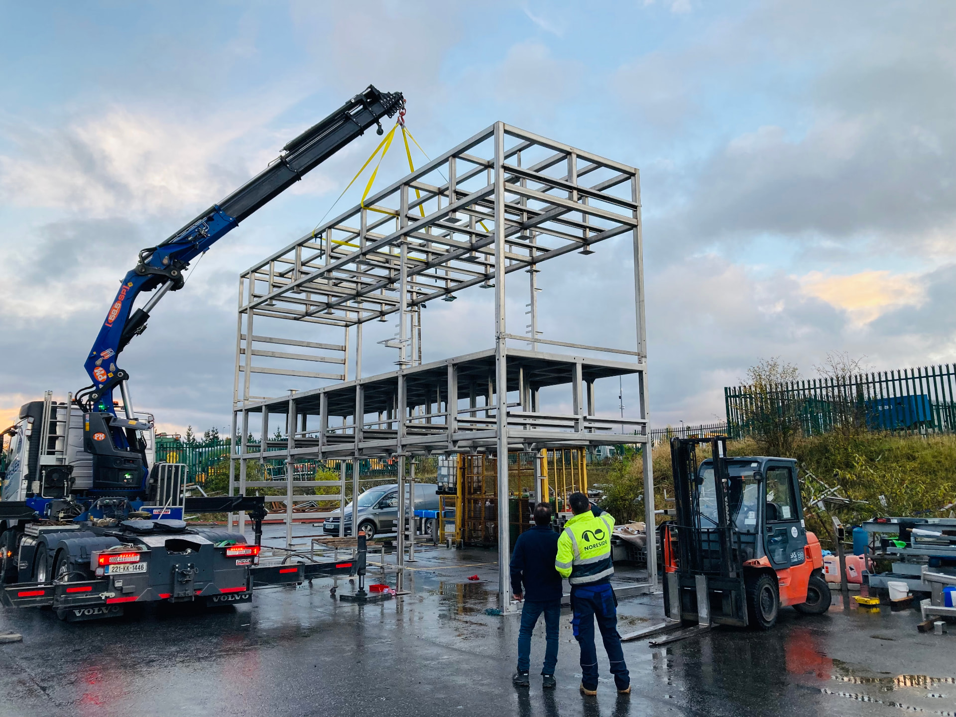 Two-storey modular stainless steel support frame being lifted by crane at NoreFab's Kilkenny facility