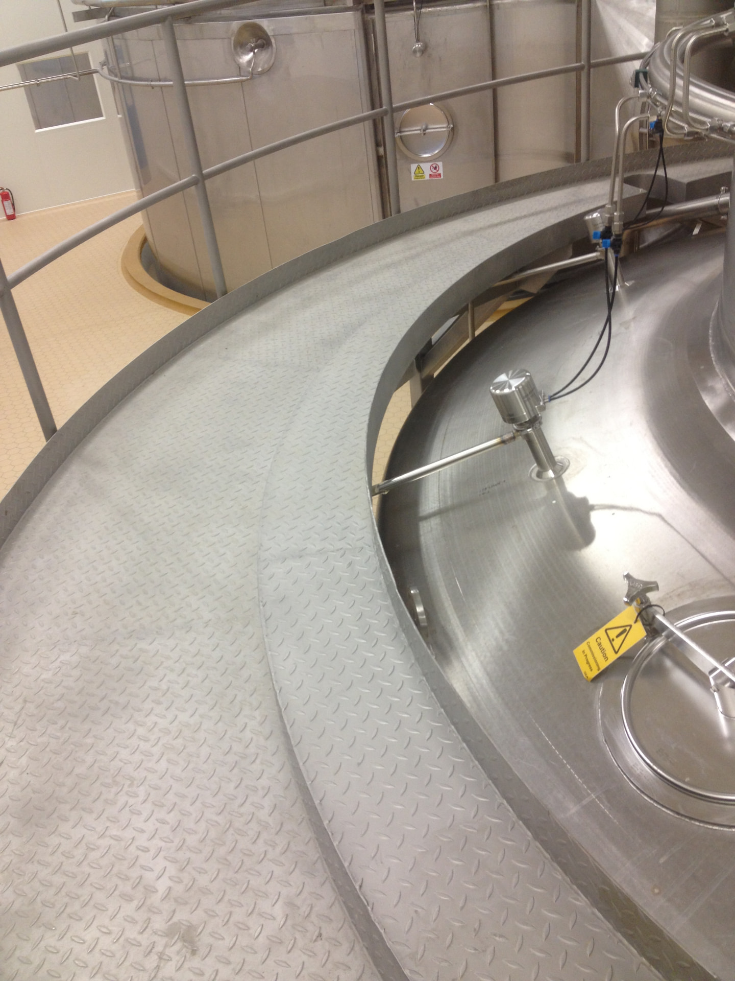 Stainless steel walkway and handrail installed around process vessels in a hygienic production area